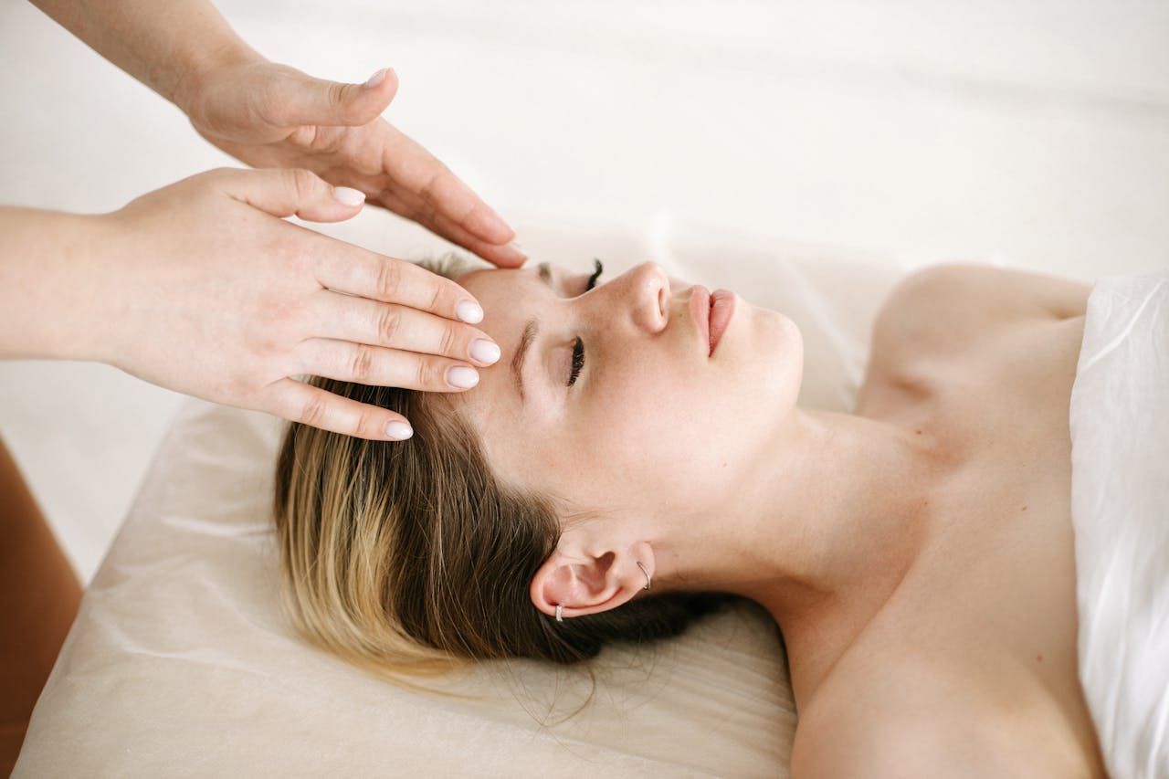 about-me-img A woman enjoying a relaxing face massage at a spa for therapeutic benefits.