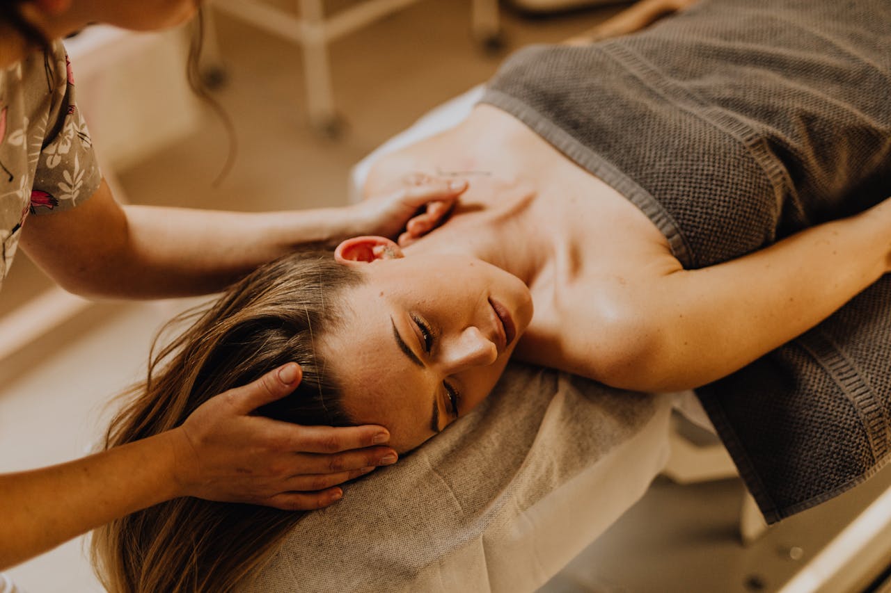 A woman enjoying a relaxing spa massage indoors. Perfect depiction of therapy and self-care.